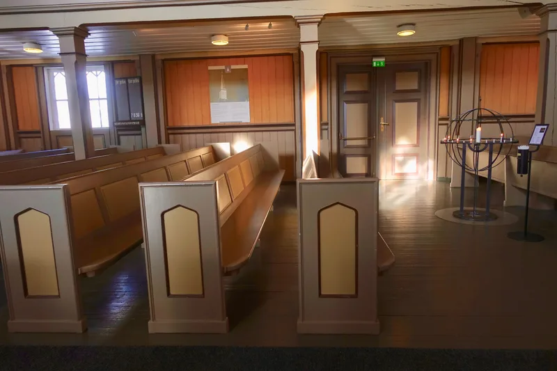 Sunlight falling across wooden pews inside a church