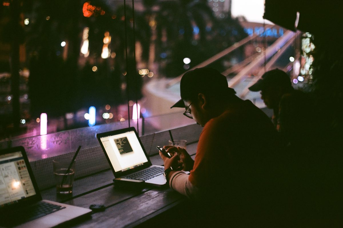 A writer working on a laptop late in the evening