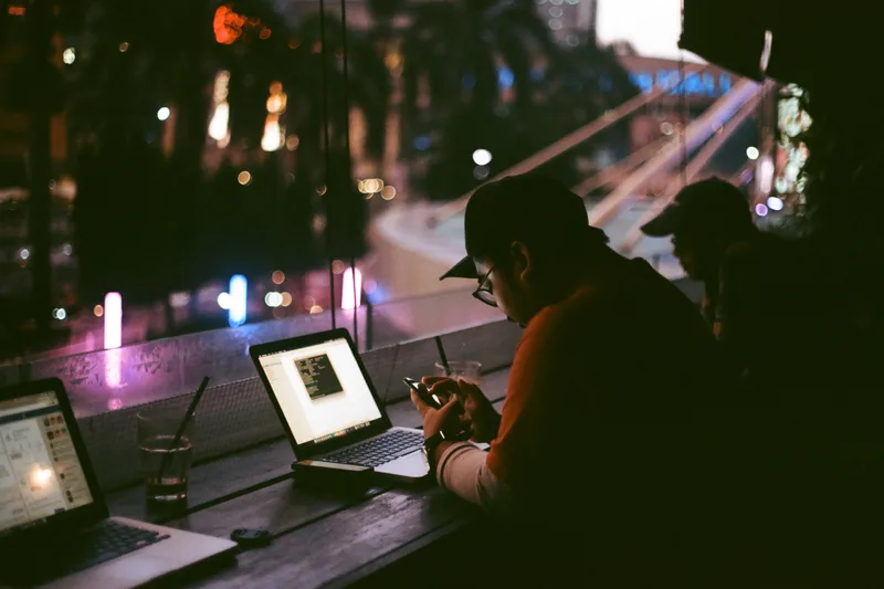 A writer working on a laptop late in the evening
