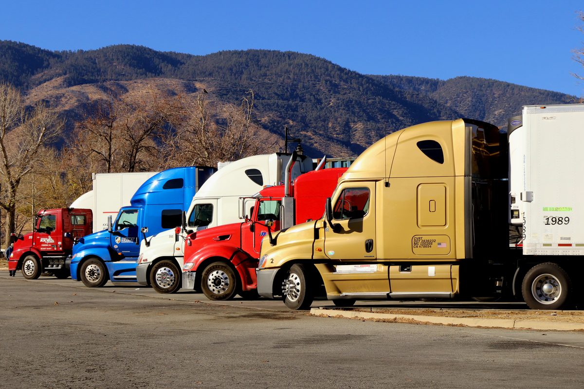 A line of semi trucks parked side by side