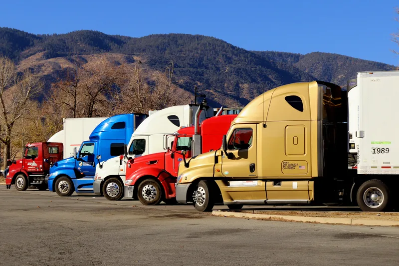 A line of semi trucks parked side by side